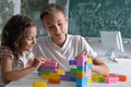 Brother and sister playing with colorful plastic blocks together Royalty Free Stock Photo