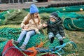 Brother and sister playing with fishing nets Royalty Free Stock Photo