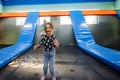 Brother with sister playing at indoor play center playground , jumping in trampoline Royalty Free Stock Photo