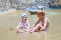Brother and sister playing in outdoors swimming pool Royalty Free Stock Photo