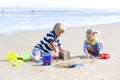 Brother and sister playing on sandy beach Royalty Free Stock Photo