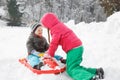 Brother and sister playing in a snowy winter landscape Royalty Free Stock Photo