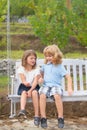 Brother and sister playing in spring park outdoors. Little boy and girl kids enjoying spring. Kids walking at backyard Royalty Free Stock Photo