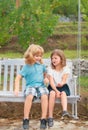 Brother and sister playing in spring park outdoors. Little boy and girl kids enjoying spring. Kids walking at backyard Royalty Free Stock Photo