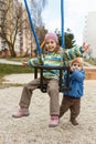 Brother and sister playing on the swing Royalty Free Stock Photo