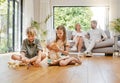 Brother, sister and playing with toys on floor with parents relax at home for bonding and care. Boy, girl and children Royalty Free Stock Photo