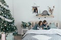 Brother and sister read an interesting book sitting in bed Royalty Free Stock Photo