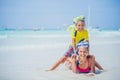 Brother and sister in scuba masks playing on the beach during the hot summer vacation day. Royalty Free Stock Photo