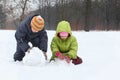 Brother and sister sculpt snowman Royalty Free Stock Photo