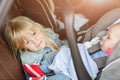 Brother and sister sitting in car in safety seat. Siblings on passenger places having fun together during travel by Royalty Free Stock Photo