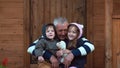 Brother and sister sitting on the grandfather s knees. Old man hugs his grandson and granddaughter. 4K