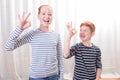 Brother and sister smiling and showing everything is fine Royalty Free Stock Photo