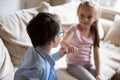 Brother and sister squeeze little fingers as sign of reconciliation