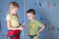 Brother and sister standing near a rock wall for climbing Royalty Free Stock Photo