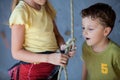 Brother and sister standing near a rock wall for climbing indoor Royalty Free Stock Photo