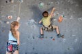 Brother and sister standing near a rock wall for climbing indoor Royalty Free Stock Photo