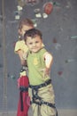 Brother and sister standing near a rock wall for climbing indoor Royalty Free Stock Photo