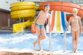 brother and sister standing by the pool with water Royalty Free Stock Photo