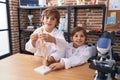 Brother and sister students smiling confident having anatomy lesson at laboratory classroom