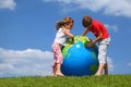 Brother with sister study map on an globe