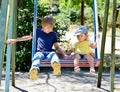 Brother and sister on the swing Royalty Free Stock Photo