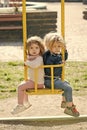 Brother and sister on swing on sunny day Royalty Free Stock Photo