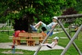 Brother with sister swinging in playground at Hallstatt, Austria Royalty Free Stock Photo