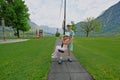 Brother with sister swinging in playground at Hallstatt, Austria Royalty Free Stock Photo