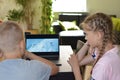 Brother and sister teens watching a movie on a computer at home