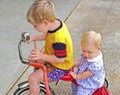 Brother and Sister on a Tricycle Royalty Free Stock Photo