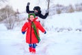 Brother and sister walk in a snowy yard, having fun with snow. Royalty Free Stock Photo