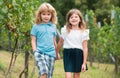 Brother and sister walking outdoors. Little boy and girl working in the garden. Two happy children in summer park. Kids Royalty Free Stock Photo