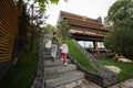 Brother with sister walking on stairs against modern wood stone house Royalty Free Stock Photo