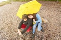 Brother and sister with yellow umbrella Royalty Free Stock Photo