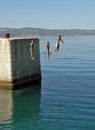 Brother and sisters jumping in water Royalty Free Stock Photo