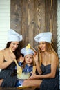 Brother and sisters at table using kitchen utensils