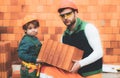 Brothers bricklayers make masonry, builders work with brick layer. Royalty Free Stock Photo