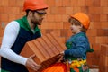 Brothers are building together. Brbuilder work with brick layer. Early childhood education concept. Royalty Free Stock Photo
