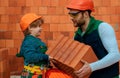 Brothers are building together. Brbuilder work with brick layer. Early childhood education concept. Royalty Free Stock Photo