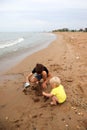 Two brothers children playing on the sand beach by the sea Royalty Free Stock Photo