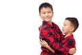 Brothers embracing, two boys wearing red team shirt isolated on white Royalty Free Stock Photo