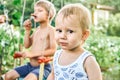 Brothers enjoy barbecue sausage at picnic on nature in countryside