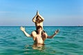 brothers are enjoying the clear warm water at the beautiful beach and playing pickaback Royalty Free Stock Photo