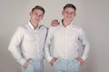 Brothers and friendship concept. Happy men hugging. Models standing together. Two brothers smiling on grey background Royalty Free Stock Photo