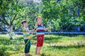 Brothers having fun splash each other with water in the village Royalty Free Stock Photo