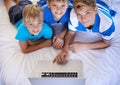 Brothers, home and playing on laptop in bedroom, above and excited for online games in house. Young children, mousepad