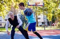 Brothers playing basketball One On One. Royalty Free Stock Photo