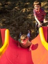 Brothers Playing on a Slide