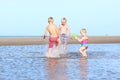 Brothers and sister playing on the beach Royalty Free Stock Photo