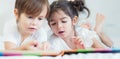 Brothers and sister read a bedtime story togather on the bed in Royalty Free Stock Photo